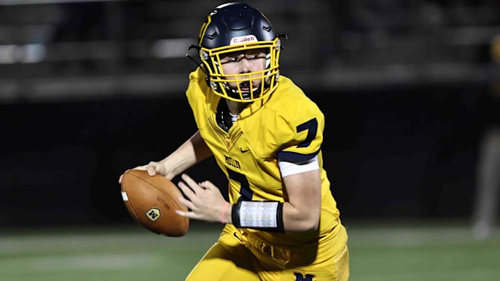 Moeller quarterback Matt Ponatoski runs the ball during a playoff game between Mason and Moeller high schools Friday, Nov. 11, 2022.