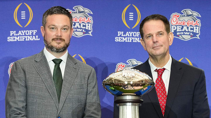 Oregon Ducks head coach Dan Lanning and Indiana Hoosiers head coach Curt Cignetti smile for a photo Thursday, Jan. 8, 2026, during a coaches' press conference ahead of the College Football Playoff Peach Bowl game at the College Football Hall of Fame in Atlanta.