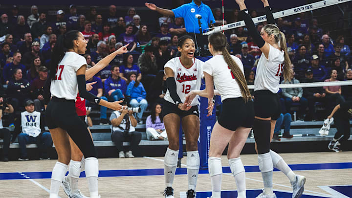 Nebraska volleyball players celebrate a point at Washington.