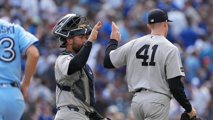 New York Yankees catcher Ali Sánchez (39) celebrates the win with relief pitcher Tim Hill (41) against the Toronto Blue Jays at the end of the tenth inning at Rogers Centre. Mandatory Credit: Nick Turchiaro-Imagn Images
