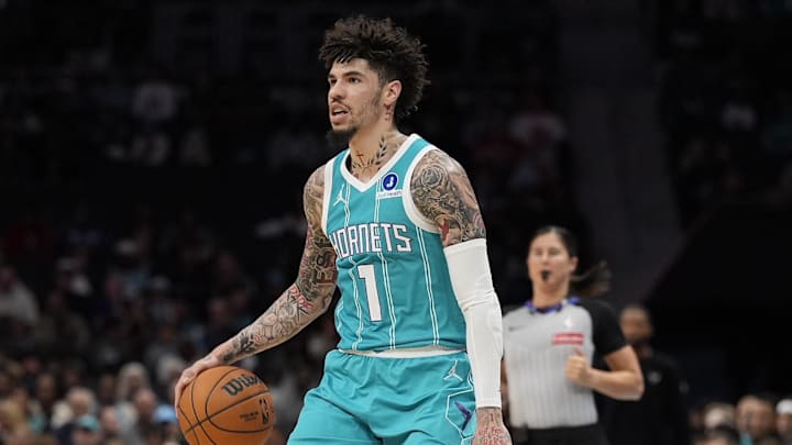Nov 1, 2025; Charlotte, North Carolina, USA; Charlotte Hornets guard LaMelo Ball (1) sets the play defended by Minnesota Timberwolves guard Mike Conley (10) during the first quarter at Spectrum Center. Mandatory Credit: Jim Dedmon-Imagn Images