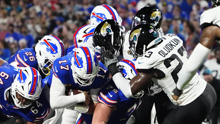 Sep 23, 2024; Orchard Park, New York, USA; Buffalo Bills quarterback Josh Allen (17) runs for a first down against the Jacksonville Jaguars during the first half at Highmark Stadium. Mandatory Credit: Gregory Fisher-Imagn Images