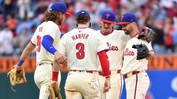 Philadelphia Phillies infielders Alec Bohm, Bryce Harper, Bryson Stott and Whit Merrifield celebrate Monday's win.