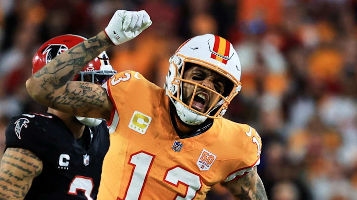 Dec 11, 2025; Tampa, Florida, USA; Tampa Bay Buccaneers wide receiver Mike Evans (13) reacts after catching a pass against Atlanta Falcons safety Jessie Bates III (3) (obscured) during the third quarter at Raymond James Stadium. Mandatory Credit: Kim Klement Neitzel-Imagn Images