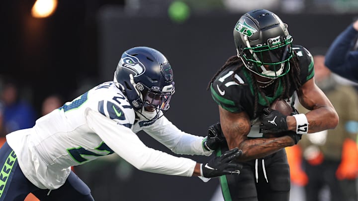 Dec 1, 2024; East Rutherford, New Jersey, USA; New York Jets wide receiver Davante Adams (17) is tackled by Seattle Seahawks cornerback Riq Woolen (27) during the second half at MetLife Stadium.