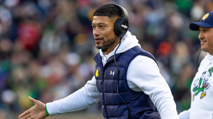 Nov 22, 2025; South Bend, Indiana, USA; Notre Dame Fighting Irish head coach Marcus Freeman celebrates with players after scoring against the Syracuse Orange during the first half at Notre Dame Stadium. Mandatory Credit: Michael Caterina-Imagn Images