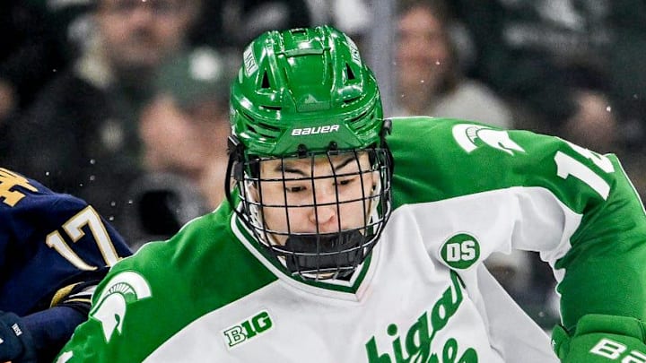 Michigan State's Ryker Lee, right, moves the puck against Notre Dame's Pano Fimis during the third period on Thursday, Feb. 19, 2026, at the Munn Ice Arena in East Lansing.
