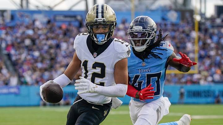 Dec 28, 2025; Nashville, Tennessee, USA; New Orleans Saints wide receiver Chris Olave (12) runs in a touchdown in front of Tennessee Titans cornerback Kemon Hall (40) during the third quarter at Nissan Stadium. Mandatory Credit: Andrew Nelles-USA TODAY Network via Imagn Images Dec 28, 2025; Nashville, Tennessee, USA; New Orleans Saints wide receiver Chris Olave (12) runs in a touchdown in front of Tennessee Titans cornerback Kemon Hall (40) during the third quarter at Nissan Stadium. Mandatory Credit: Andrew Nelles-USA TODAY Network via Imagn Images