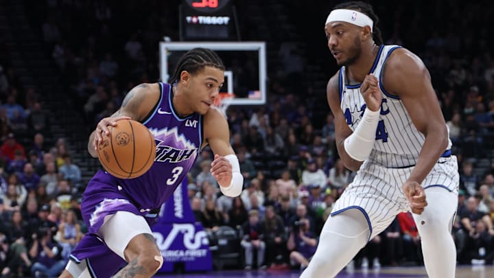 Dec 20, 2025; Salt Lake City, Utah, USA; Utah Jazz guard Keyonte George (3) drives against Orlando Magic center Wendell Carter Jr. (34) during the second half at Delta Center. Mandatory Credit: Rob Gray-Imagn Images