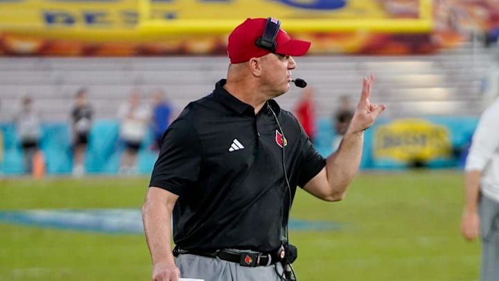 Dec 23, 2025; Boca Raton, FL, USA; Louisville Cardinals head coach Jeff Brohm signals to his team during a time out in the fourth quarter of the Boca Raton Bowl at Flagler CU Stadium. Mandatory Credit: Jeff Romance-Imagn Images