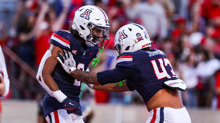 Nov 8, 2025; Tucson, Arizona, USA; Arizona Wildcats defensive backs Treydan Stukes and Dalton Johnson celebrate a win against the Kansas Jayhawks at the end of the game at Arizona Stadium. Mandatory Credit: Aryanna Frank-Imagn Images