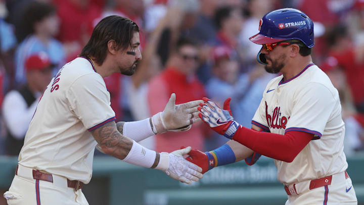 Oct 5, 2024; Philadelphia, PA, USA; Philadelphia Phillies designated hitter Kyle Schwarber (12) celebrates with Philadelphia Phillies outfielder Nick Castellanos (8) after hitting a solo home run against the New York Mets in the first inning in game one of the NLDS for the 2024 MLB Playoffs at Citizens Bank Park