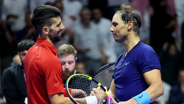 Novak Djokovic and Rafael Nadal shake hands at the net after a match at the Six Kings Slam.