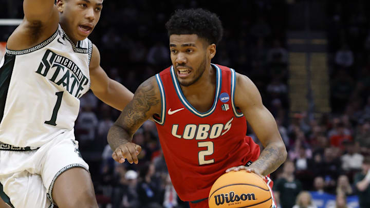 Mar 23, 2025; Cleveland, OH, USA; New Mexico Lobos guard Donovan Dent (2) dribbles the ball defended by Michigan State Spartans guard Jeremy Fears Jr. (1) in the second half during the NCAA Tournament Second Round at Rocket Arena. Mandatory Credit: Rick Osentoski-Imagn Images Mar 23, 2025; Cleveland, OH, USA; New Mexico Lobos guard Donovan Dent (2) dribbles the ball defended by Michigan State Spartans guard Jeremy Fears Jr. (1) in the second half during the NCAA Tournament Second Round at Rocket Arena. Mandatory Credit: Rick Osentoski-Imagn Images