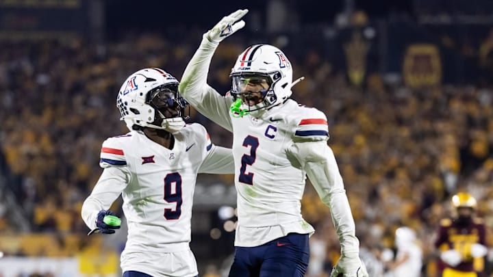Nov 28, 2025; Tempe, Arizona, USA; Arizona Wildcats defensive back Treydan Stukes (2) celebrates with defensive back Ayden Garnes (9) after an interception against Arizona State Sun Devils in the second half during the 99th Territorial Cup at Mountain America Stadium. Mandatory Credit: Mark J. Rebilas-Imagn Images Nov 28, 2025; Tempe, Arizona, USA; Arizona Wildcats defensive back Treydan Stukes (2) celebrates with defensive back Ayden Garnes (9) after an interception against Arizona State Sun Devils in the second half during the 99th Territorial Cup at Mountain America Stadium. Mandatory Credit: Mark J. Rebilas-Imagn Images