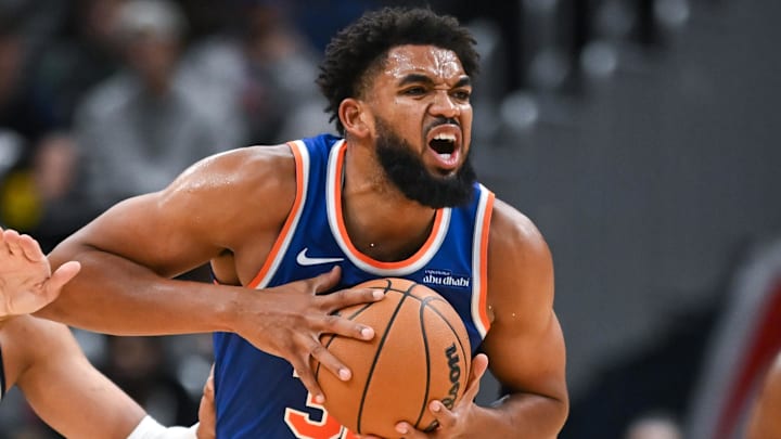 Oct 18, 2024; Washington, District of Columbia, USA; New York Knicks center Karl-Anthony Towns (32) reacts while being defended by Washington Wizards forward Patrick Baldwin Jr. (7) during the second quarter at Capital One Arena. Mandatory Credit: Reggie Hildred-Imagn Images