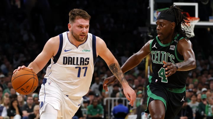 Jun 9, 2024; Boston, Massachusetts, USA; Dallas Mavericks guard Luka Doncic (77) dribbles the ball against Boston Celtics guard Jrue Holiday (4) during the first quarter in game two of the 2024 NBA Finals at TD Garden. Mandatory Credit: Peter Casey-USA TODAY Sports