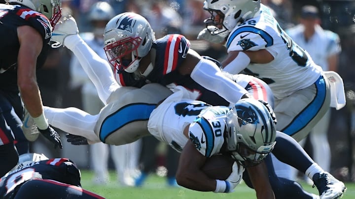 Sep 28, 2025; Foxborough, Massachusetts, USA; New England Patriots linebacker K'Lavon Chaisson (44) tackles Carolina Panthers running back Chuba Hubbard (30) during the first half at Gillette Stadium. Mandatory Credit: Bob DeChiara-Imagn Images