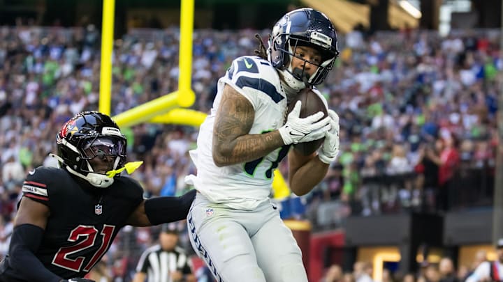 Dec 8, 2024; Glendale, Arizona, USA; Seattle Seahawks wide receiver Jaxon Smith-Njigba (11) catches a touchdown pass against Arizona Cardinals cornerback Garrett Williams (21) in the first half at State Farm Stadium.