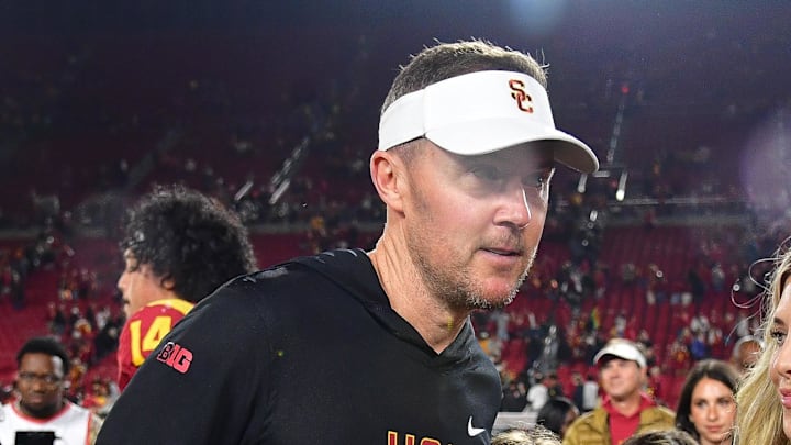 Nov 7, 2025; Los Angeles, California, USA; Southern California Trojans head coach Lincoln Riley meets with wife Caitlin and daughers Sloan and Stella following the victory against the Northwestern Wildcats at the Los Angeles Memorial Coliseum. Mandatory Credit: Gary A. Vasquez-Imagn Images