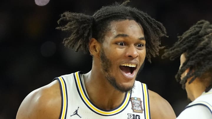 Apr 6, 2026; Indianapolis, IN, USA; Michigan Wolverines forward Morez Johnson Jr. (21) and Michigan Wolverines guard Roddy Gayle Jr. (11) celebrate after defeating the Connecticut Huskies in the national championship of the Final Four of the men's 2026 NCAA Tournament at Lucas Oil Stadium. Mandatory Credit: Robert Deutsch-Imagn Images