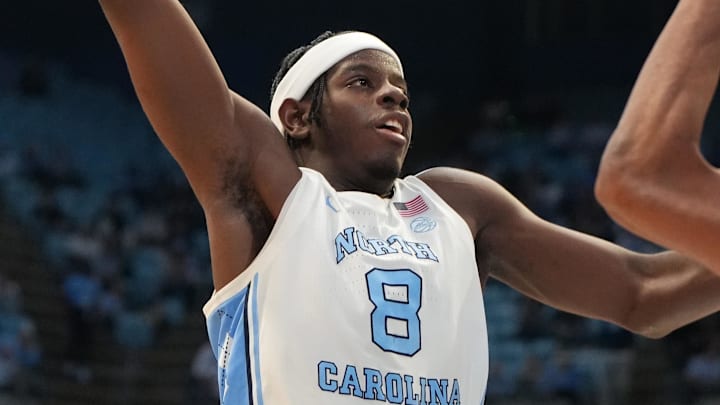 Dec 13, 2025; Chapel Hill, North Carolina, USA; North Carolina Tar Heels forward Caleb Wilson (8) shoots as USC Upstate Spartans forward Jafeth Martinez (12) defends in the second half at Dean E. Smith Center. Mandatory Credit: Bob Donnan-Imagn Images