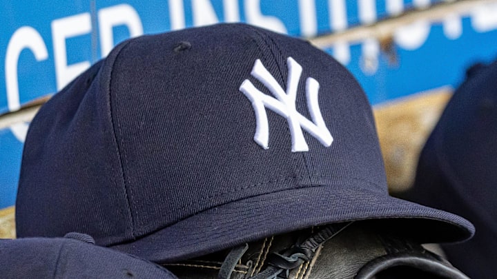 Apr 7, 2025; Detroit, Michigan, USA; New York Yankees baseball hats and gloves in the dugout out in the eighth inning against the Detroit Tigers at Comerica Park. 