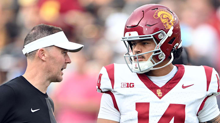 Sep 13, 2025; West Lafayette, Indiana, USA;  Southern California Trojans quarterback Jayden Maiava (14) talks with Southern California Trojans head coach Lincoln Riley  before the game against the Purdue Boilermakers at Ross-Ade Stadium. 