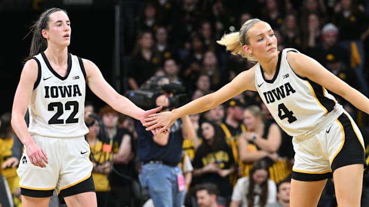 Mar 3, 2024; Iowa City, Iowa, USA; Iowa Hawkeyes guard Caitlin Clark (22) reacts with guard Kylie Feuerbach (4) during the game against the Ohio State Buckeyes. Clark broke the NCAA basketball all-time scoring record during the second quarter at Carver-Hawkeye Arena. Mandatory Credit: Jeffrey Becker-Imagn Images Mar 3, 2024; Iowa City, Iowa, USA; Iowa Hawkeyes guard Caitlin Clark (22) reacts with guard Kylie Feuerbach (4) during the game against the Ohio State Buckeyes. Clark broke the NCAA basketball all-time scoring record during the second quarter at Carver-Hawkeye Arena. Mandatory Credit: Jeffrey Becker-Imagn Images