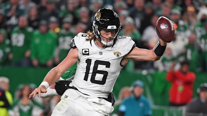 Nov 3, 2024; Philadelphia, Pennsylvania, USA; Jacksonville Jaguars quarterback Trevor Lawrence (16) scores a touchdown  past Philadelphia Eagles safety Reed Blankenship (32) during the fourth quarter at Lincoln Financial Field. Mandatory Credit: Eric Hartline-Imagn Images