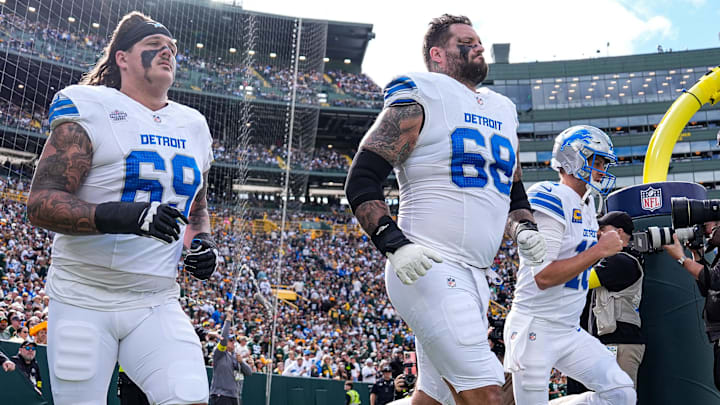 Detroit Lions guard Tate Ratledge (69), tackle Taylor Decker (68) and quarterback Jared Goff (16) take the field for the first half against the Green Bay Packers at Lambeau Field in Green Bay, Wis., on Sunday, September 7, 2025.