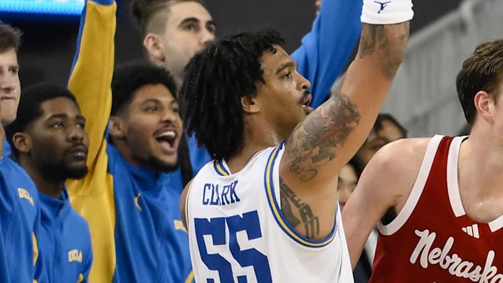 Mar 3, 2026; Los Angeles, California, USA; UCLA Bruins guard Skyy Clark (55) shoots a 3-point jump shot as teammate on the bench celebrate in the second half against the Nebraska Cornhuskers at Pauley Pavilion presented by Wescom Financial. Mandatory Credit: Robert Hanashiro-Imagn Images