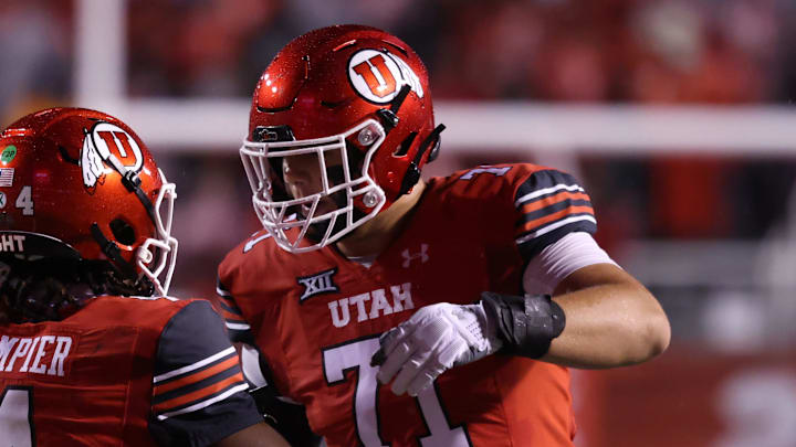 Oct 11, 2025; Salt Lake City, Utah, USA; Utah Utes quarterback Devon Dampier (4) celebrates scoring a touchdown against the Arizona State Sun Devils with Utah Utes offensive lineman Caleb Lomu (71) during the second quarter at Rice-Eccles Stadium. Mandatory Credit: Rob Gray-Imagn Images