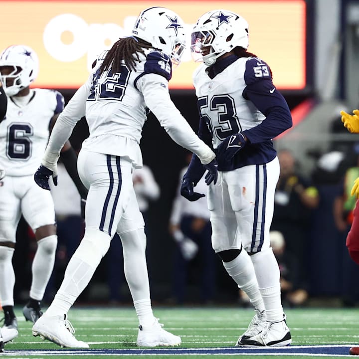 Dallas Cowboys EDGE Jadeveon Clowney and EDGE James Houston celebrate after a sack against the Washington Commanders.