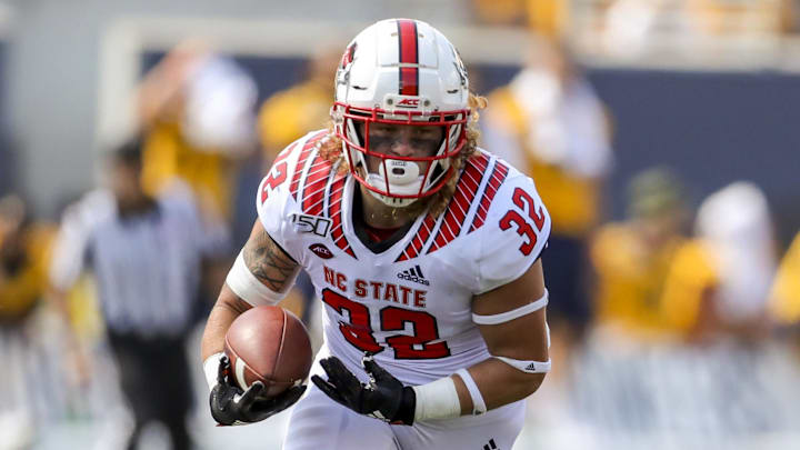 Sep 14, 2019; Morgantown, WV, USA; North Carolina State Wolfpack linebacker Drake Thomas (32) runs after intercepting a pass during the third quarter against the West Virginia Mountaineers at Mountaineer Field at Milan Puskar Stadium. Mandatory Credit: Ben Queen-Imagn Images