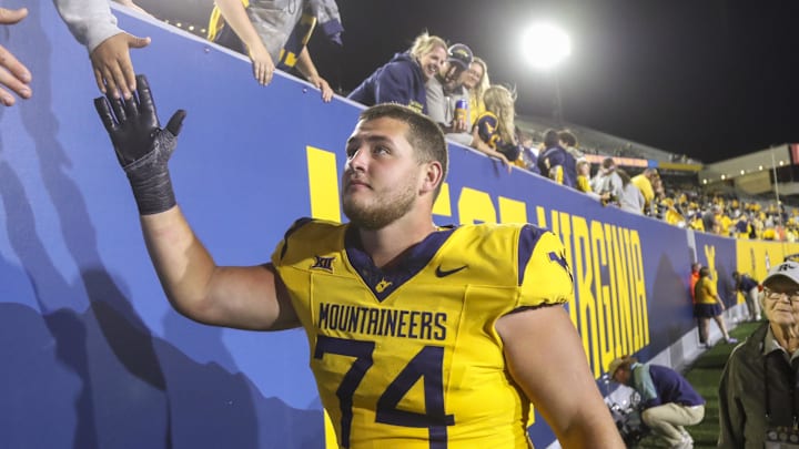 Sep 7, 2024; Morgantown, West Virginia, USA; West Virginia Mountaineers offensive lineman Wyatt Milum (74) celebrates with fans after defeating the Albany Great Danes at Mountaineer Field at Milan Puskar Stadium. Mandatory Credit: Ben Queen-Imagn Images