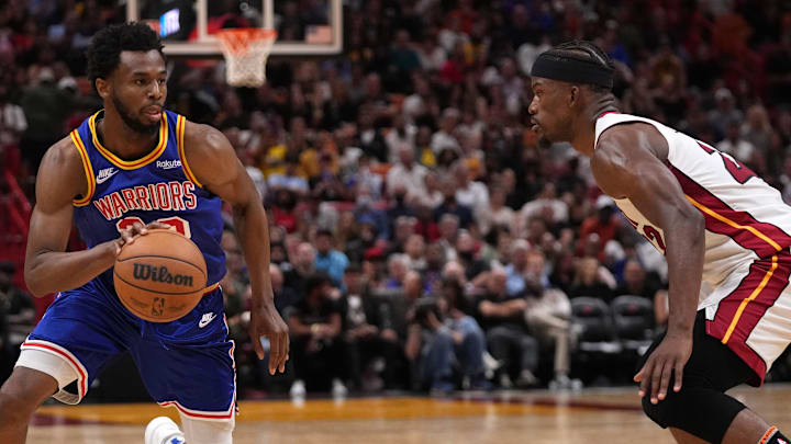 Mar 23, 2022; Miami, Florida, USA; Golden State Warriors forward Andrew Wiggins (22) drives the ball around Miami Heat forward Jimmy Butler (22) during the second half at FTX Arena. Mandatory Credit: Jasen Vinlove-Imagn Images