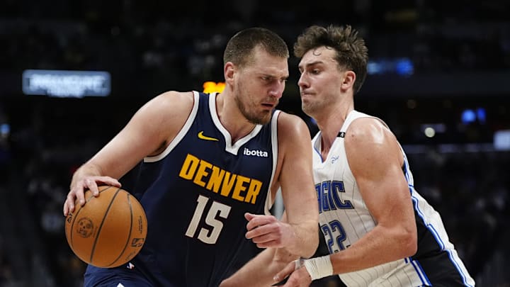 Feb 6, 2025; Denver, Colorado, USA; Denver Nuggets center Nikola Jokic (15) drives against Orlando Magic forward Franz Wagner (22) in the second quarter at Ball Arena.