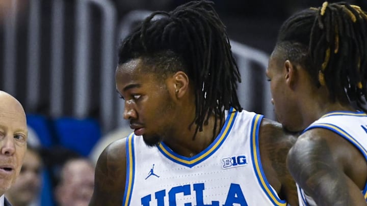 Nov 4, 2024; Los Angeles, California, USA; UCLA Bruins head coach Mick Cronin with guards Sebastian Mack (12) and Dylan Andrews (2) during the first half against the Rider Broncs  at Pauley Pavilion presented by Wescom. Mandatory Credit: Robert Hanashiro-Imagn Images