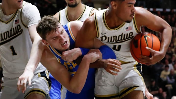 Purdue Boilermakers forward Caleb Furst (1), UCLA Bruins forward Tyler Bilodeau (34) and Purdue Boilermakers guard C.J. Cox (0) fight for a rebound Friday, Feb. 28, 2025, during the NCAA men’s basketball game at Mackey Arena in West Lafayette, Ind. Purdue Boilermakers forward Caleb Furst (1), UCLA Bruins forward Tyler Bilodeau (34) and Purdue Boilermakers guard C.J. Cox (0) fight for a rebound Friday, Feb. 28, 2025, during the NCAA men’s basketball game at Mackey Arena in West Lafayette, Ind.
