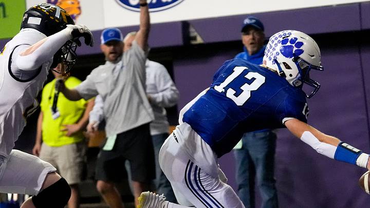 West Lyon’s Easton DeJong (13) runs into the endzone after catching a pass in a trick play Nov. 20, 2025 during the Class 1A state football championship against the Iowa City Regina Regals at the UNI-Dome in Cedar Falls, Iowa. West Lyon’s Easton DeJong (13) runs into the endzone after catching a pass in a trick play Nov. 20, 2025 during the Class 1A state football championship against the Iowa City Regina Regals at the UNI-Dome in Cedar Falls, Iowa.