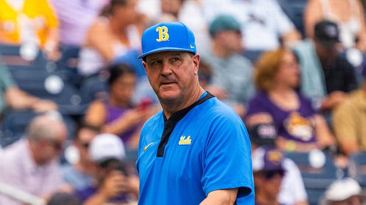 Jun 16, 2025; Omaha, Neb, USA; UCLA Bruins head coach John Savage walks off the field before the game against the LSU Tigers at Charles Schwab Field. Mandatory Credit: Dylan Widger-Imagn Images