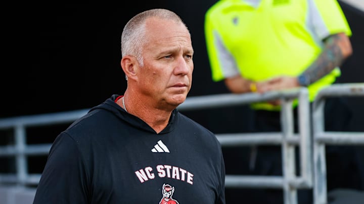 Aug 28, 2025; Raleigh, North Carolina, USA; North Carolina State Wolfpack head coach Dave Doeren walks out during the warmups prior to the game against East Carolina Pirates at Carter-Finley Stadium. Mandatory Credit: Jaylynn Nash-Imagn Images Aug 28, 2025; Raleigh, North Carolina, USA; North Carolina State Wolfpack head coach Dave Doeren walks out during the warmups prior to the game against East Carolina Pirates at Carter-Finley Stadium. Mandatory Credit: Jaylynn Nash-Imagn Images
