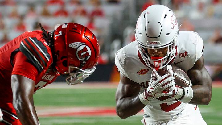 Arkansas Razorbacks running back Sutton Smith (5) runs the ball against Utah Utes linebacker Johnathan Hall (7) and safety Rabbit Evans (1) during the first quarter at Rice-Eccles Stadium. Arkansas Razorbacks running back Sutton Smith (5) runs the ball against Utah Utes linebacker Johnathan Hall (7) and safety Rabbit Evans (1) during the first quarter at Rice-Eccles Stadium.