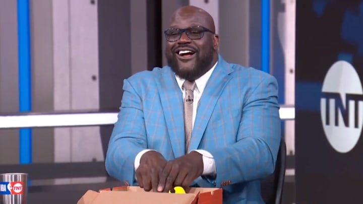 Shaq giving CPR to a stuffed animal Hawk.