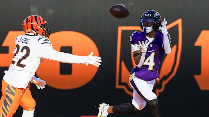 Dec 14, 2025; Cincinnati, Ohio, USA; Baltimore Ravens wide receiver Zay Flowers (4) catches a pass for a touchdown in the first half against Cincinnati Bengals safety Geno Stone (22) at Paycor Stadium. Mandatory Credit: Katie Stratman-Imagn Images