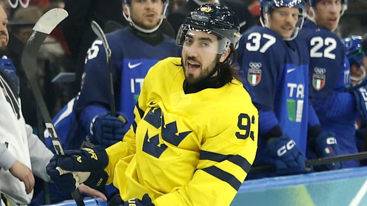 Feb 11, 2026; Milan, Italy; Mika Zibanejad of Sweden celebrates scoring their fourth goal as Italy players look on in men's ice hockey group B play during the Milano Cortina 2026 Olympic Winter Games at Milano Santagiulia Ice Hockey Arena. Mandatory Credit: Geoff Burke-Imagn Images Feb 11, 2026; Milan, Italy; Mika Zibanejad of Sweden celebrates scoring their fourth goal as Italy players look on in men's ice hockey group B play during the Milano Cortina 2026 Olympic Winter Games at Milano Santagiulia Ice Hockey Arena. Mandatory Credit: Geoff Burke-Imagn Images