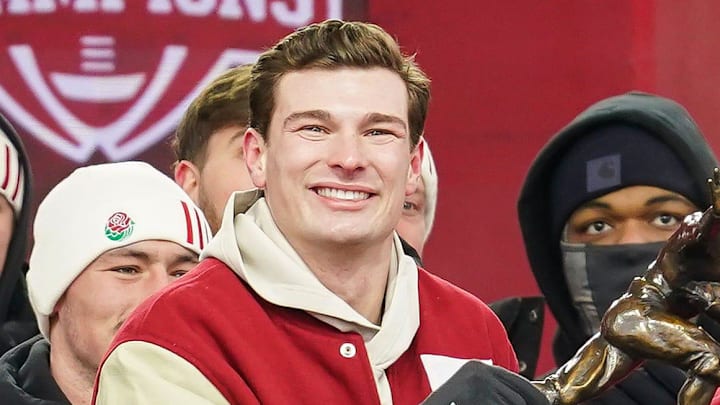 Indiana Hoosiers quarterback Fernando Mendoza (15) holds the Heisman Trophy with Indiana Hoosiers head coach Curt Cignetti on Saturday, Jan. 24, 2026, during the Indiana Football College Football Playoff National Championship celebration and parade at Memorial Stadium in Bloomington.