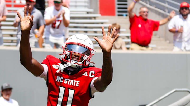 Sep 6, 2025; Raleigh, North Carolina, USA; North Carolina State Wolfpack quarterback CJ Bailey (11) celebrates a touchdown with fans during the first half of the game against Virginia Cavaliers at Carter-Finley Stadium. Mandatory Credit: Jaylynn Nash-Imagn Images