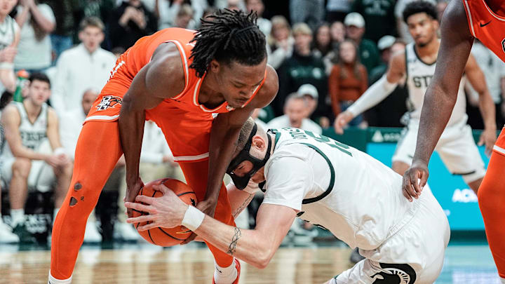 Bowling Green guard Javontae Campbell (2) and Michigan State center Carson Cooper (15) battle for the ball during the second half at Breslin Center in East Lansing on Saturday, Nov. 16, 2024.